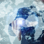 A business professional interacts with a glowing digital world map surrounded by futuristic cybersecurity and data interface graphics.