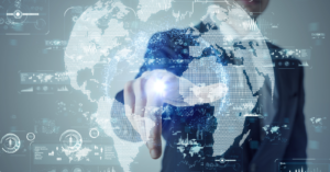 A business professional interacts with a glowing digital world map surrounded by futuristic cybersecurity and data interface graphics.